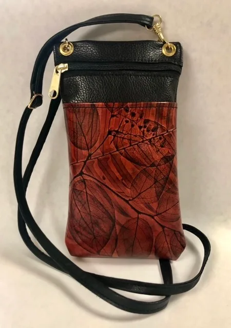 Jose Leaf Leather Bag with adjustable crossbody strap.