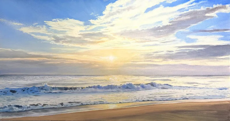 A golden sunrise over gentle waves
