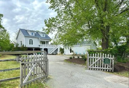 Photo of view of artist's home and separate studio and gallery from the driveway entrance.
